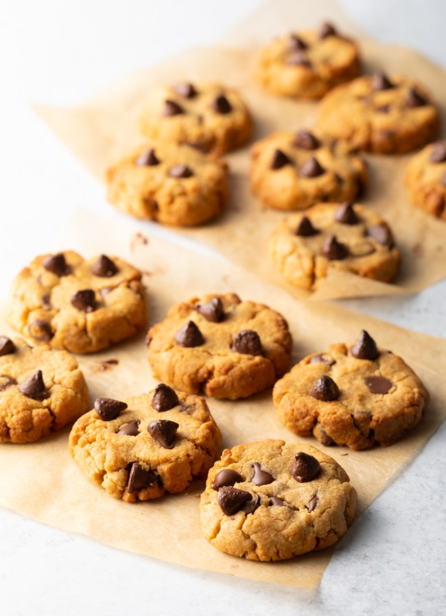 Air fryer chocolate chip cookies freshly baked on parchment paper.