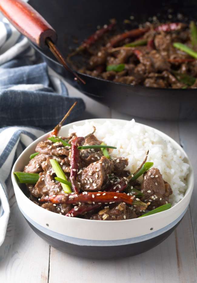 Final Szechuan Beef recipe in a bowl served with some white rice
