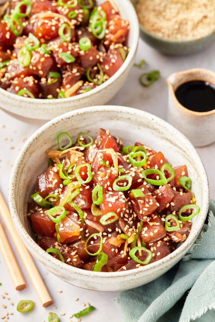 poke-recipe.jpg Two bowls full of ahi poke with a side of soy sauce.