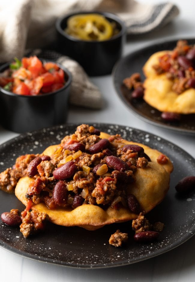 Taco meat and beans on top of a crispy tortilla.