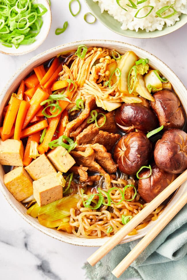 Pork Sukiyaki in a bowl with chopsticks