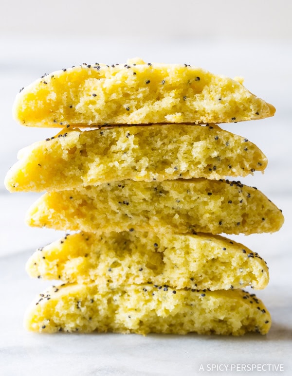 Lemon Poppy Seed Cookies #ASpicyPerspective #Lemon #PoppySeed #SoftCookies #EasyLemonCookies #PoppySeedRecipes #PoppySeedCookies #Summer #Spring #Easter Lemon poppy seed cookies broken in half and stacked on top of each other.