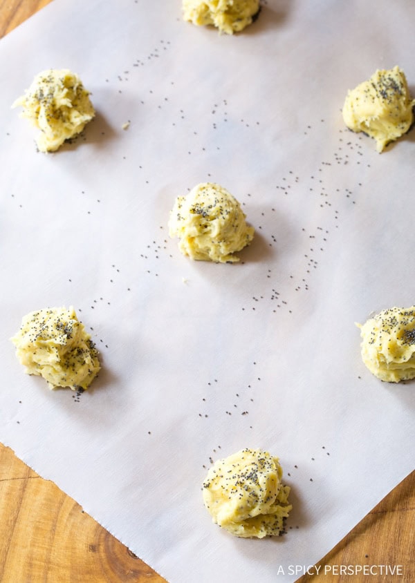 Lemon Poppy Seed Cookies #ASpicyPerspective #Lemon #PoppySeed #SoftCookies #EasyLemonCookies #PoppySeedRecipes #PoppySeedCookies #Summer #Spring #Easter Cookie dough balls on a baking sheet lined with parchment paper.
