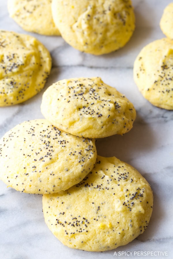 Lemon Poppy Seed Cookies #ASpicyPerspective #Lemon #PoppySeed #SoftCookies #EasyLemonCookies #PoppySeedRecipes #PoppySeedCookies #Summer #Spring #Easter Lemon poppy seed cookies scattered on a kitchen counter.