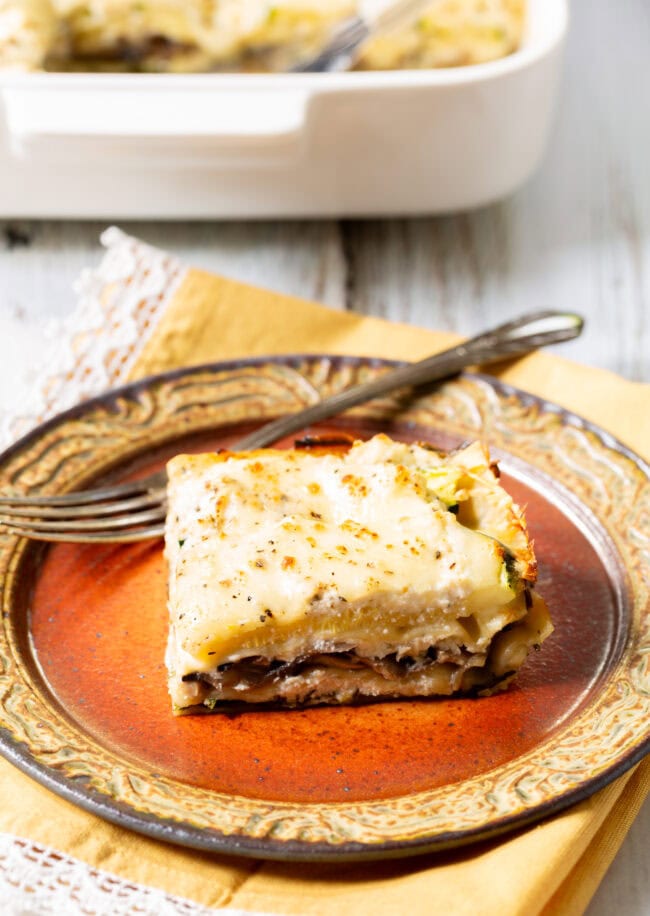 White vegetable lasagna assembled in a white baking dish before being baked.